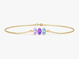 Gold chain bracelet with three oval gemstones: amethyst, aquamarine, and peridot
