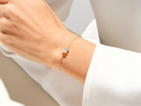Gold bracelet with colorful gemstones on a woman's wrist