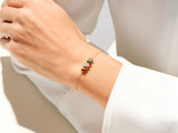 Gold bracelet with colorful gemstones on a woman's wrist