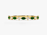 Gold ring with alternating emerald and diamond gemstones