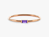Rose gold ring with a single purple baguette gemstone