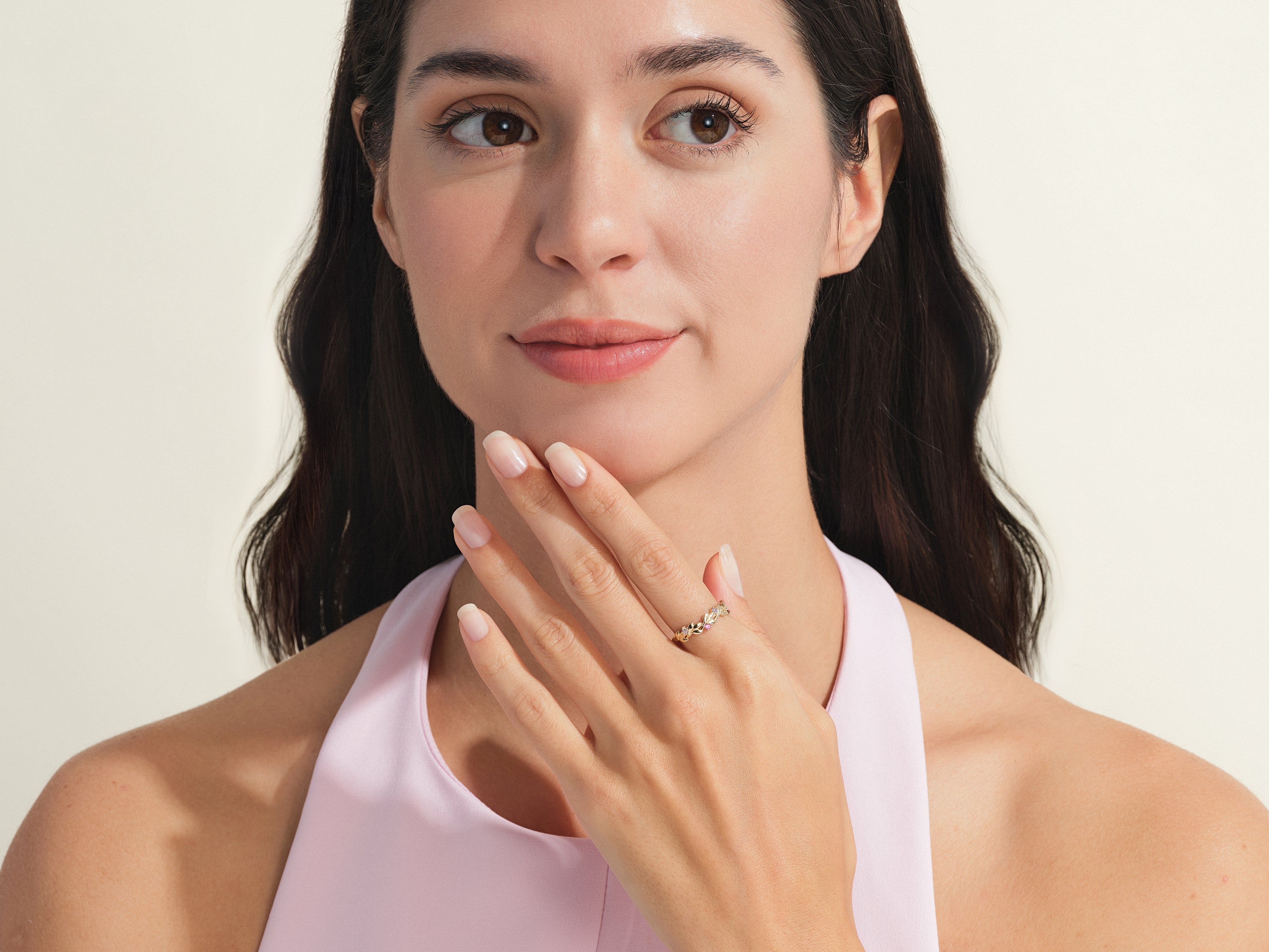 Woman wearing a delicate gold floral ring from a jewelry collection