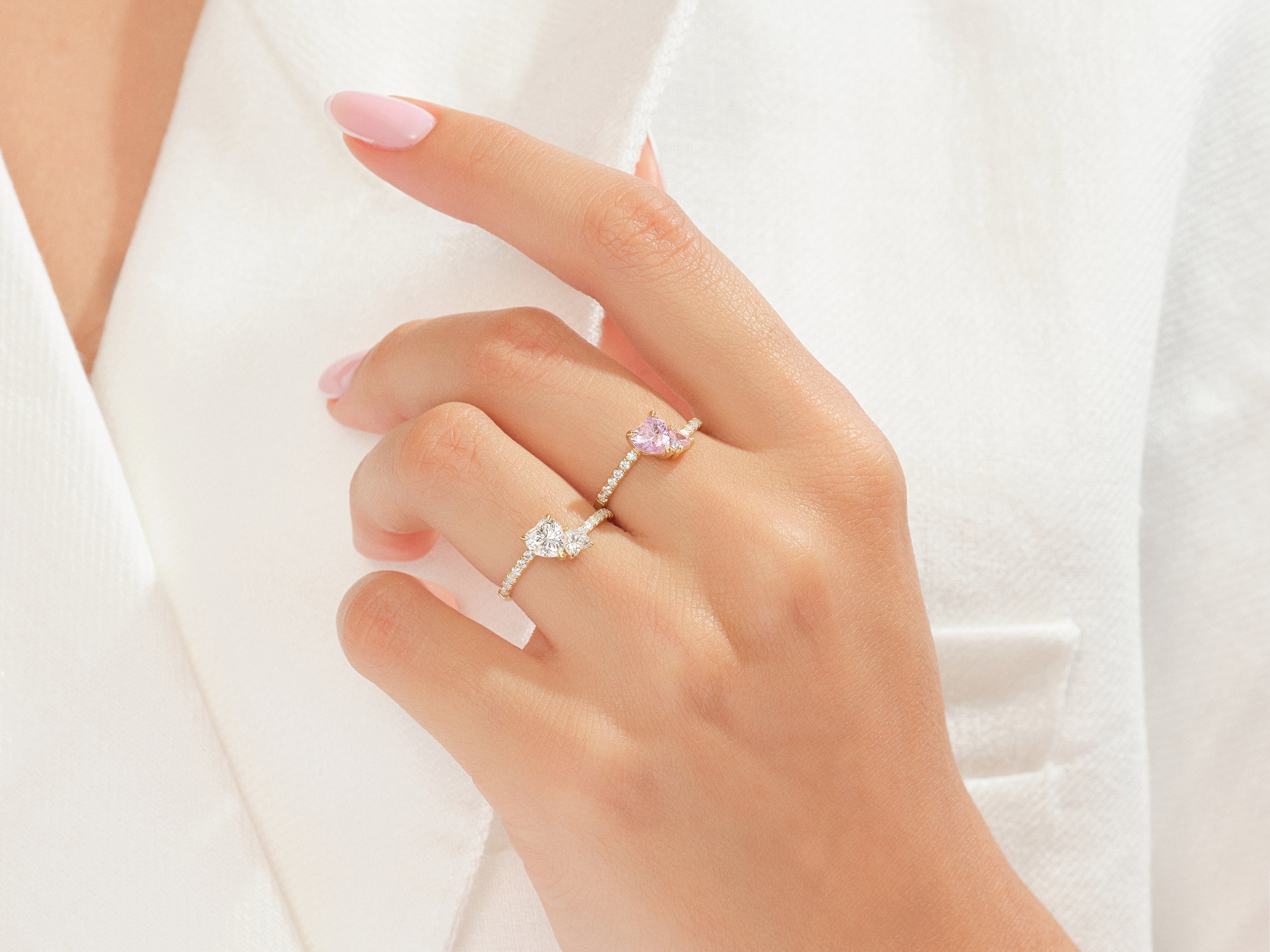 Diamond and pink sapphire rings on a hand, jewelry
