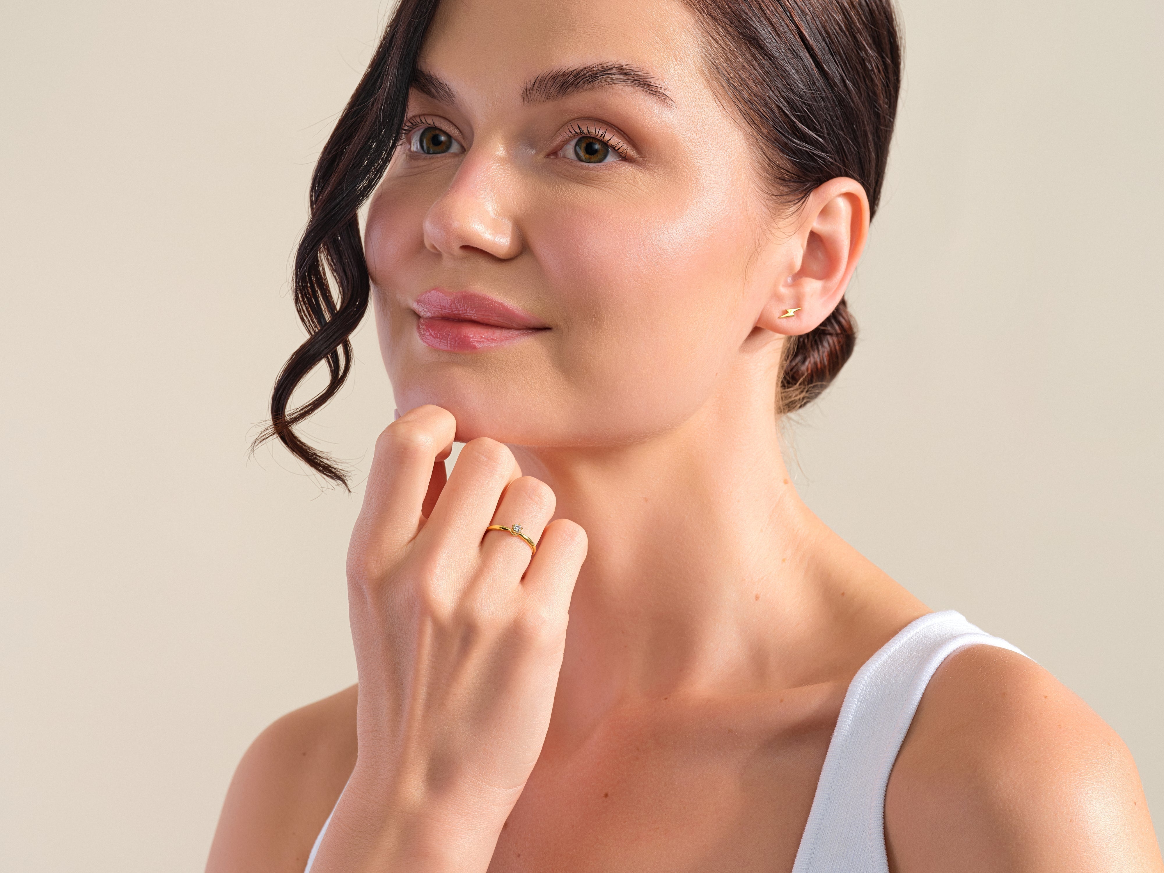 Woman wearing diamond ring and lightning bolt earring from jewelry collection