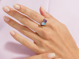 Jewelry ring with purple and blue gemstones on a hand