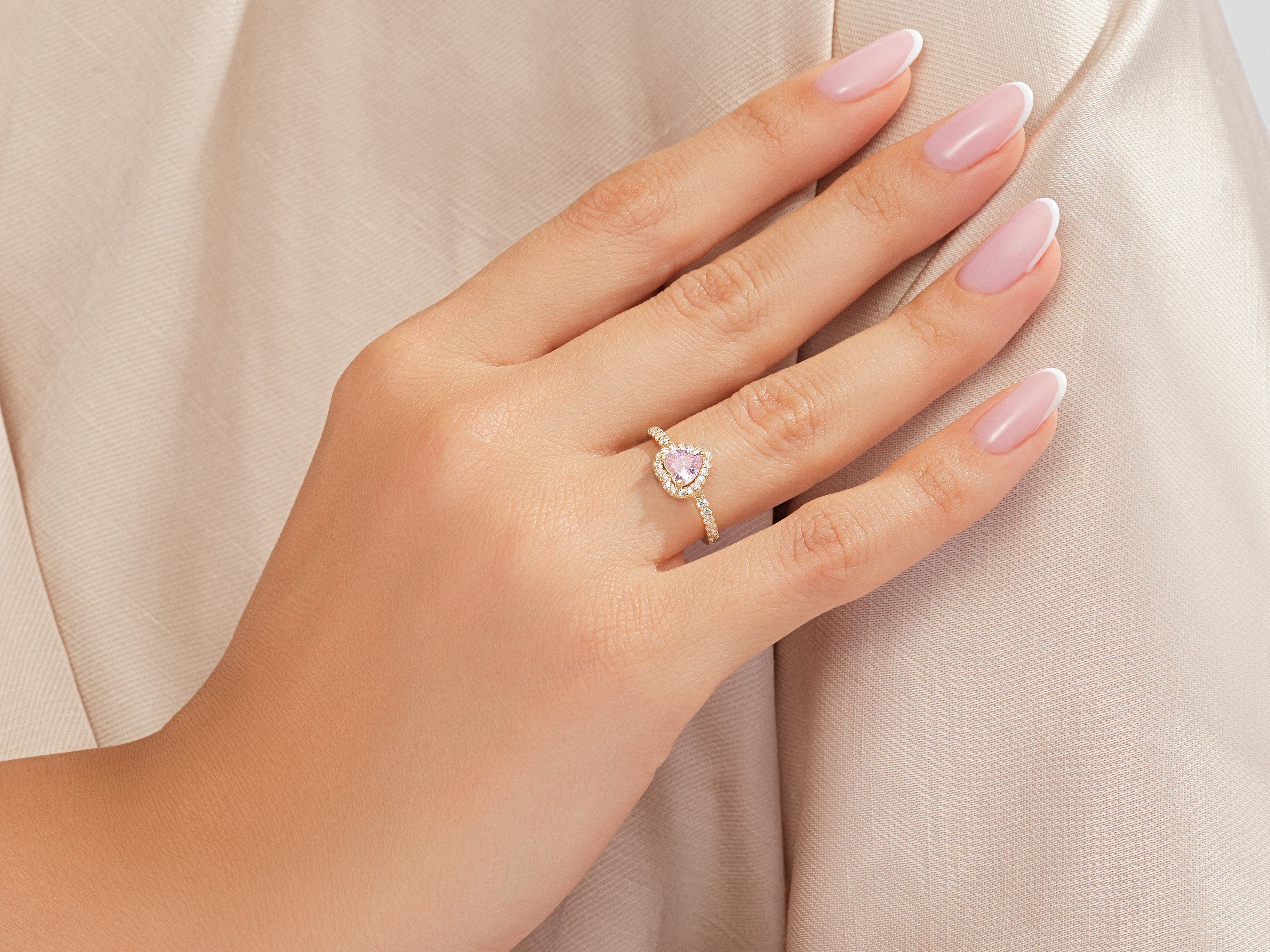 Pink heart diamond ring on a woman's hand