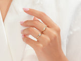 Diamond and gold rings on a woman's hand