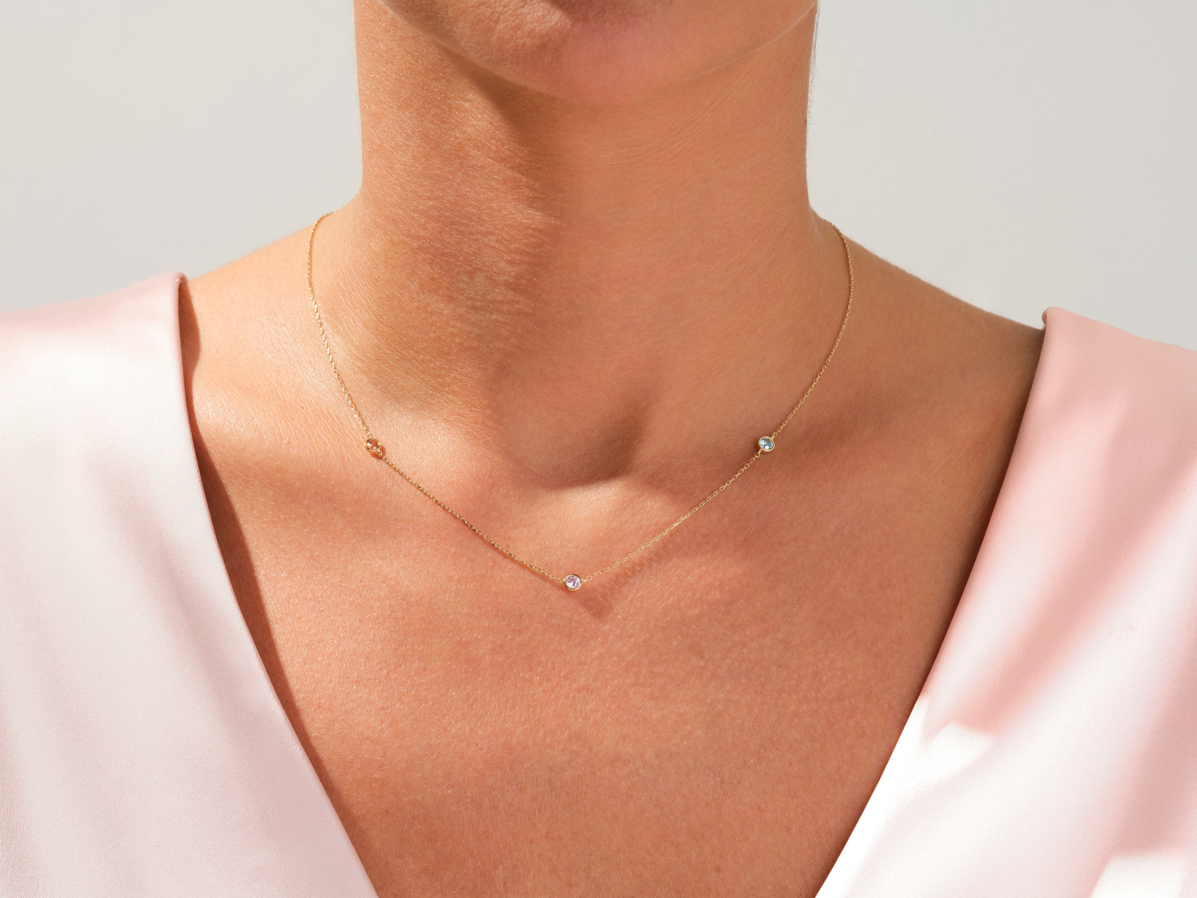 Gold necklace with scattered diamonds on a woman's neck