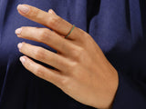 Emerald eternity ring on a hand, fine jewelry