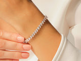 Diamond tennis bracelet with pear-shaped stones on a woman's wrist
